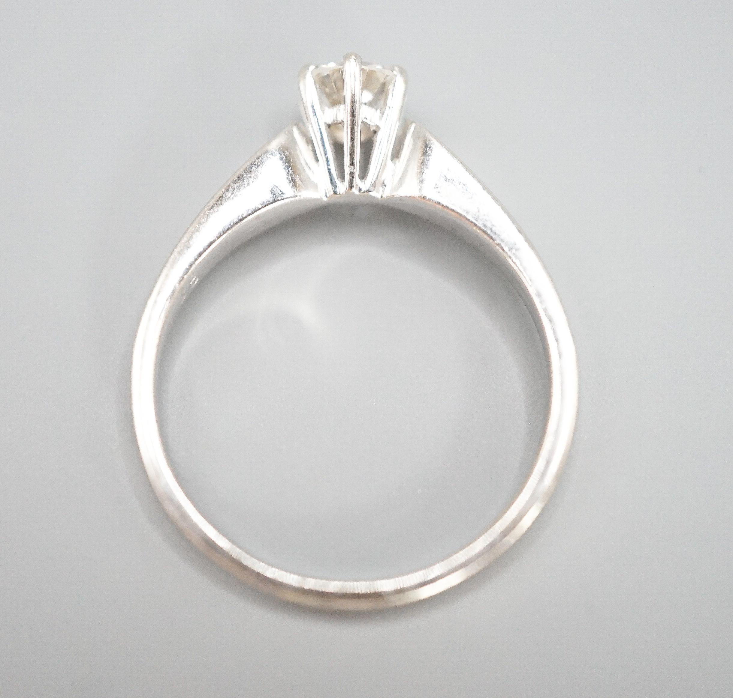 A modern white metal and solitaire diamond ring, size M, gross weight 2.3 grams.